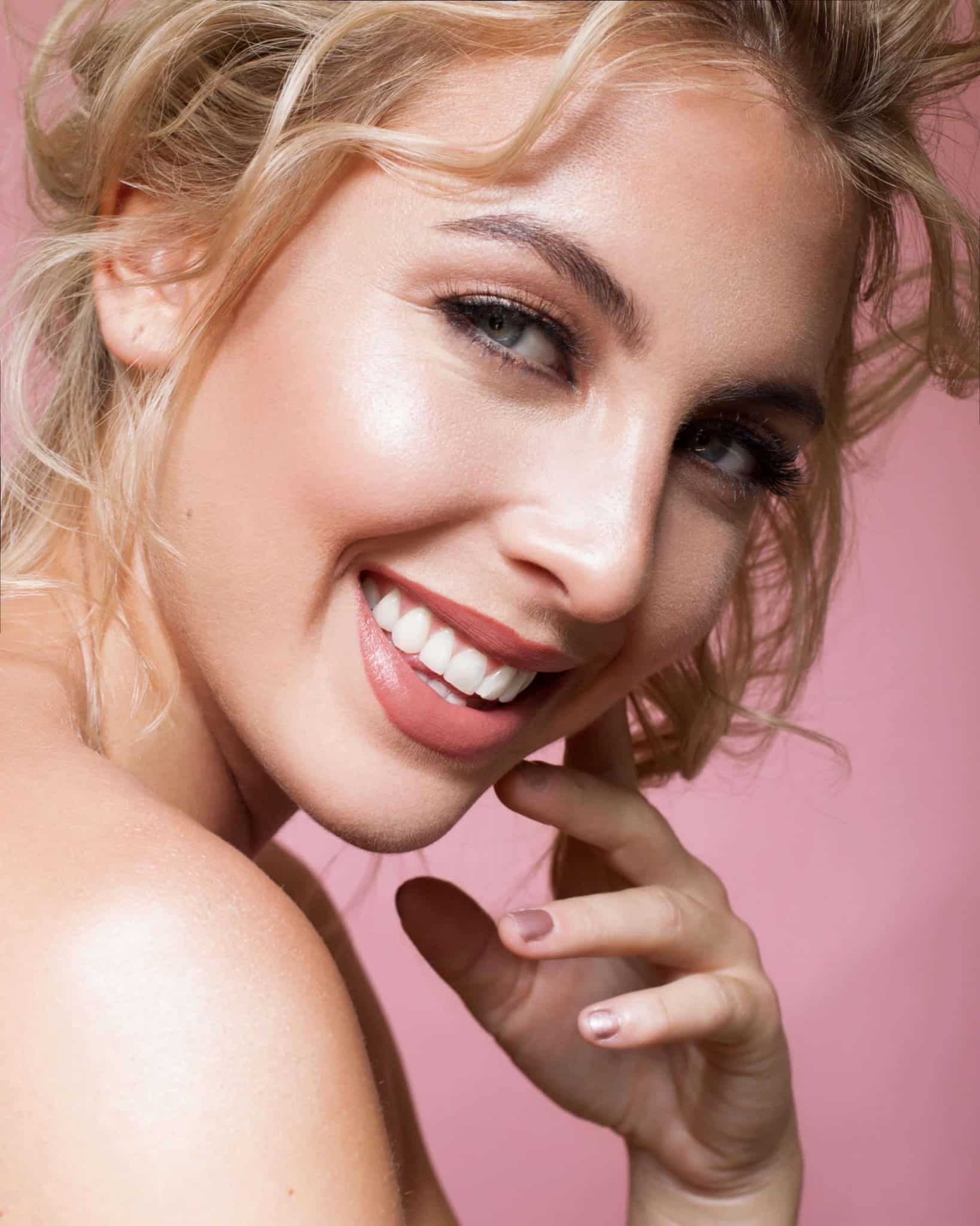 close up beautiful bridal makeup for blue eyes. Light pink eye with a nude, glossy lip