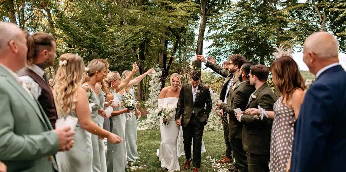bride and groom just married and confetti bring poured on them in france