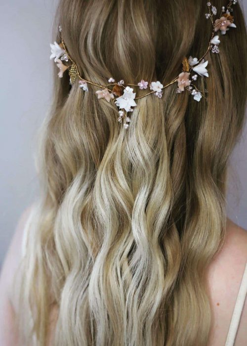 half up half down, curly bridal hairstyle with flowered hair vine