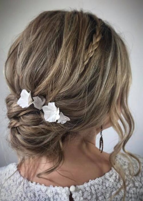 messy bun with braid and flower hair pins