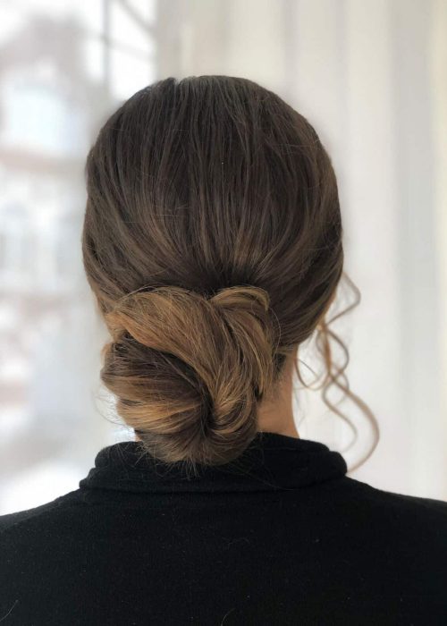 bun hairstyle with soft, face framing pieces