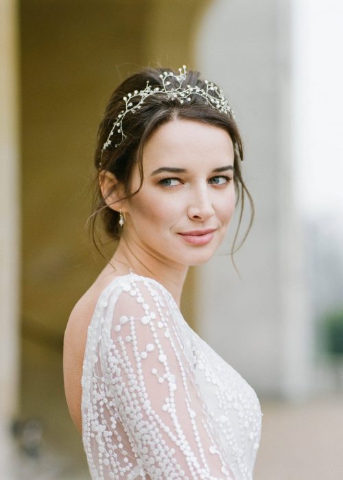 close up of bride in wedding dress with hair framing the face and a soft, natural makeup look
