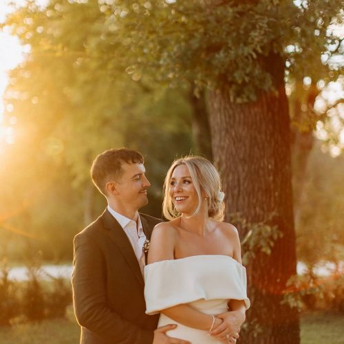 bride and groom at sunset, bride with natural makeup and hair in bun hairstyle